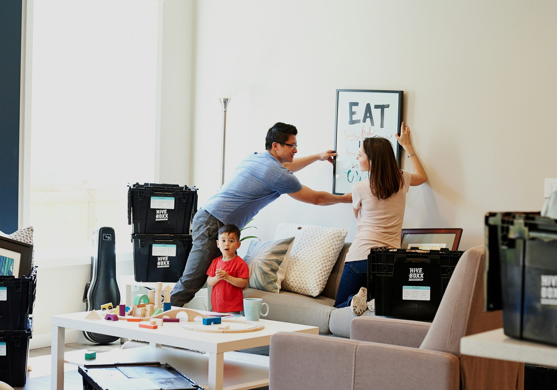 A family unpacking boxes in their new home